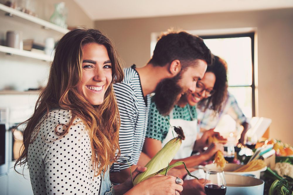 Woman with a corn in the kitchen with her friends