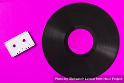 Audio cassette tape and vinyl record on pink background 4O9mo0