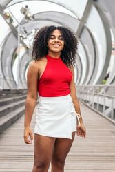 Portrait of a woman with afro hair enjoying in summer in the city