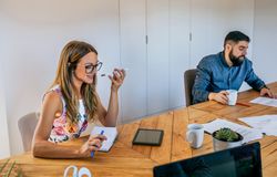 Office worker talking mobile phone with speaker