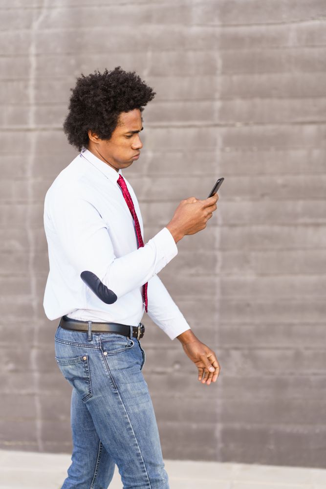 Intense man outside looking at his phone