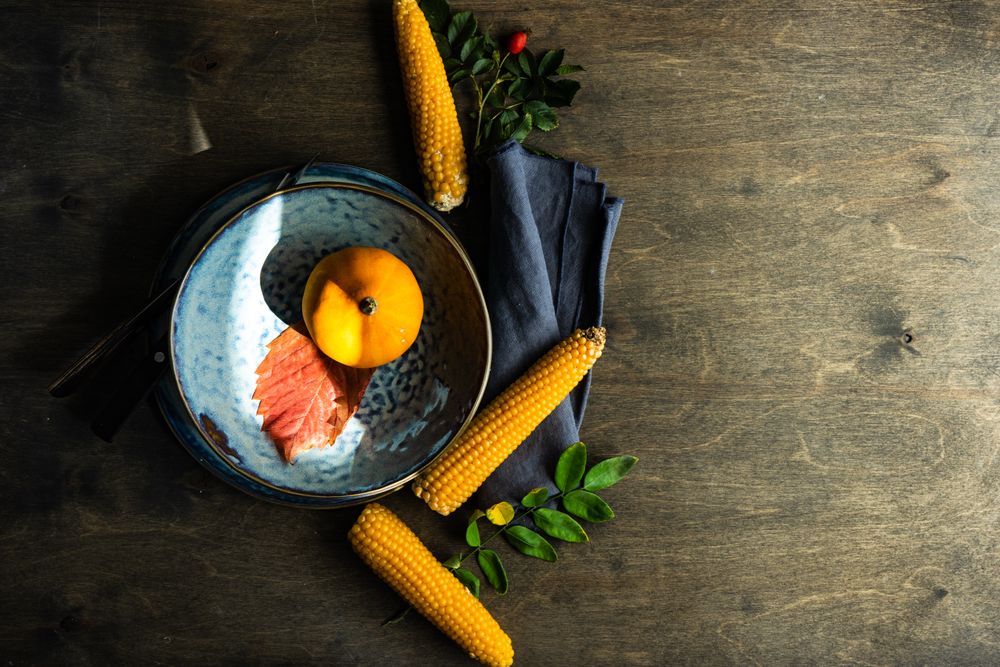 Top view of squash in blue bowl with decorative corn