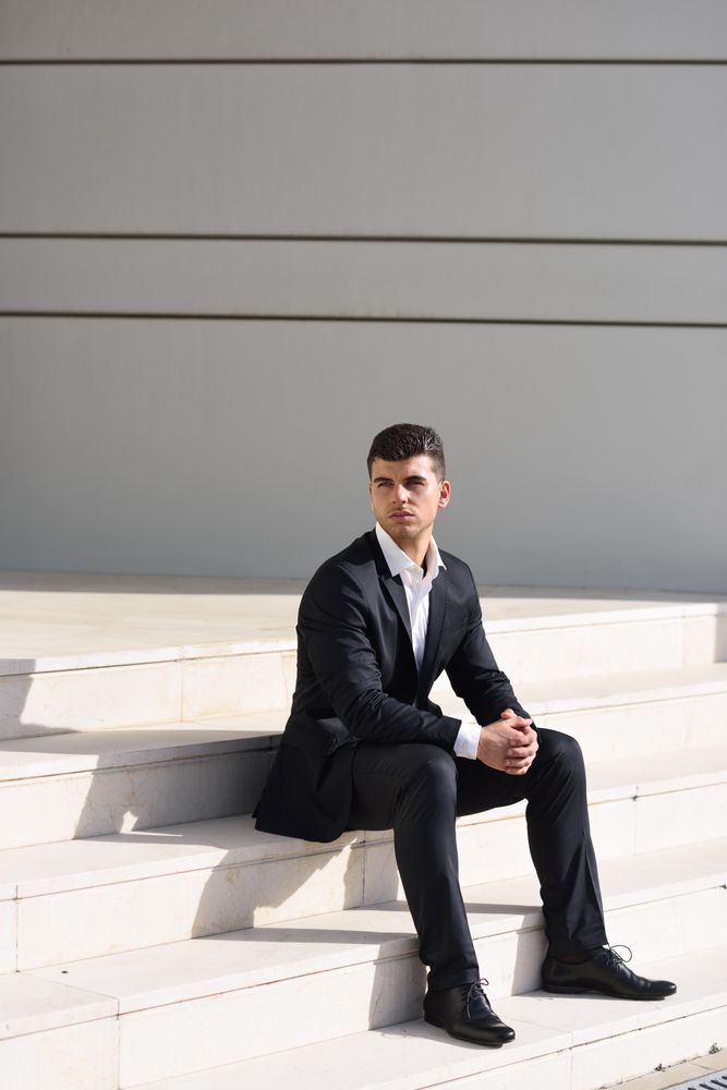 Man sitting tall on stairs