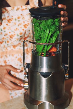 woman using electric mixer to prepare vegetarian