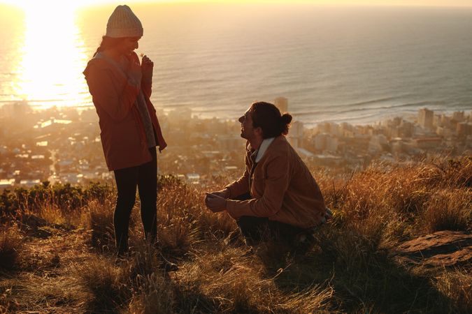 Couple in love in mountain with seascape in background
