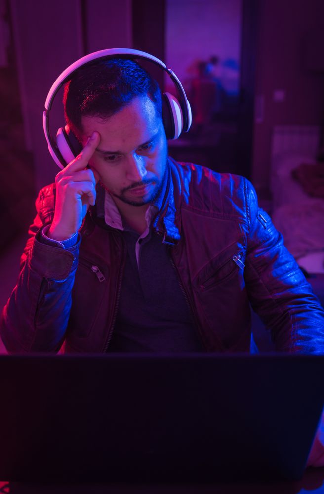 Man listening cheerfully to music with headphones.