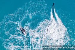 Overhead shot of person jet blading and another on a jet ski 5rNp35
