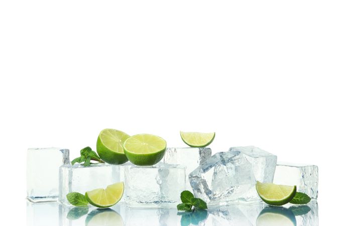 Ice cubes with slices of lime, and mint leaves, copy space