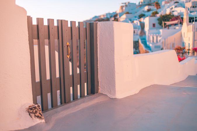 Wooden gate with Santorini in background at sunset