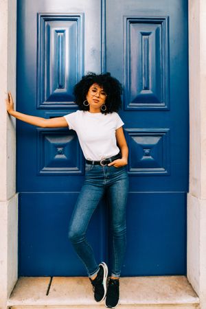 Black female by blue door