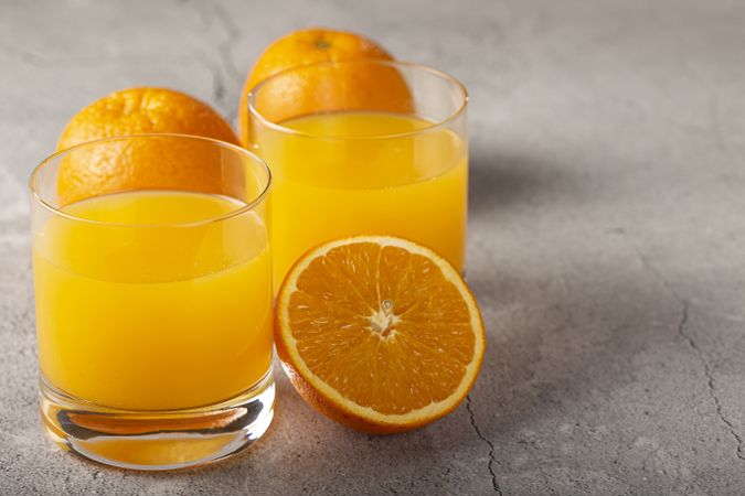 Glass with orange juice on the table.