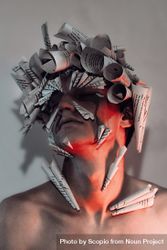 Portrait of young man with paper cones on his head and eyes 0yQXq0