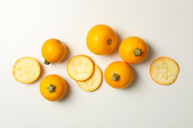 Round zucchini and slices on neutral background, top view
