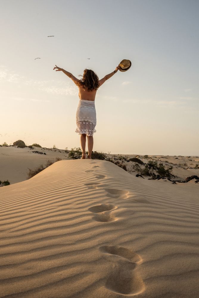 Active woman walking in dry desert barefoot