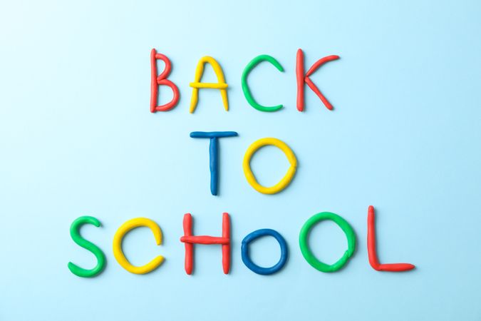 Inscription back to school on color background, space for text