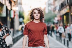 man walking along city street