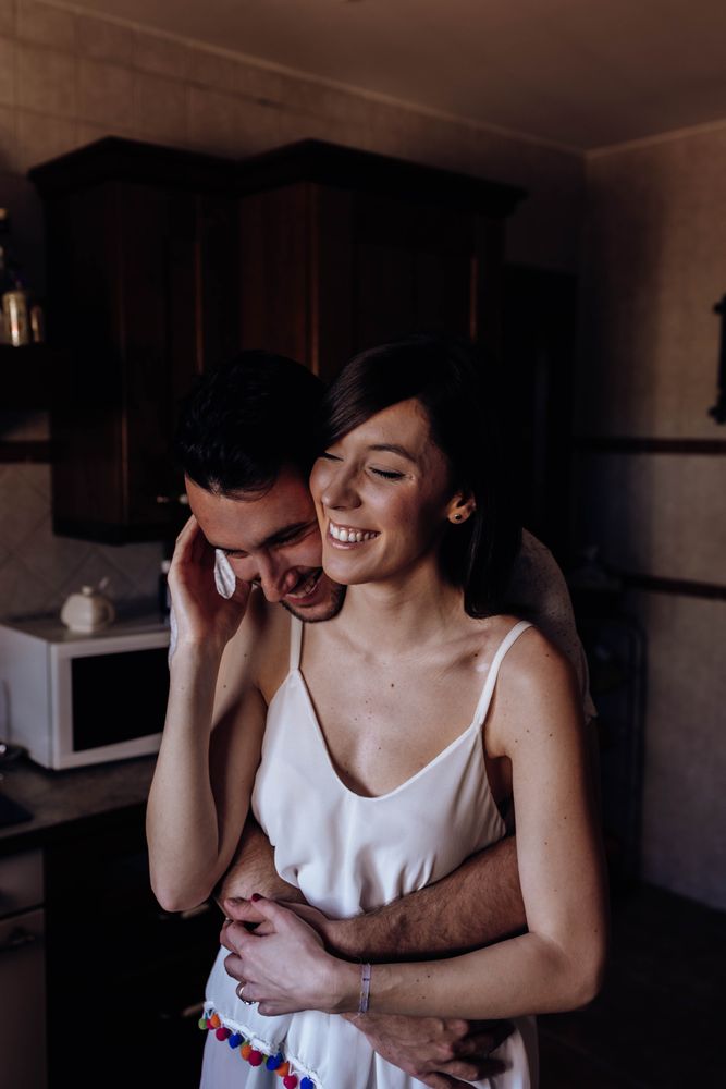 Happy couple embracing in kitchen