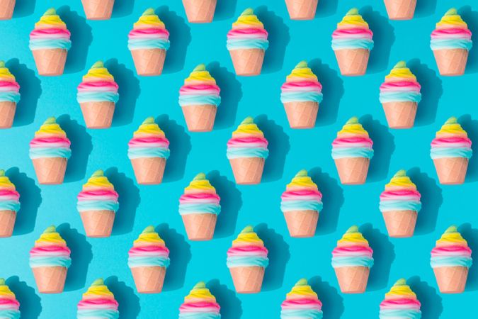 Pattern of colorful rows of ice cream on bright blue background