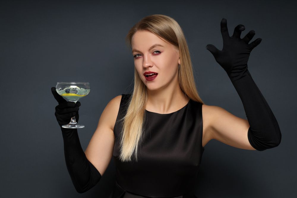 Concept of Halloween, young woman on dark background