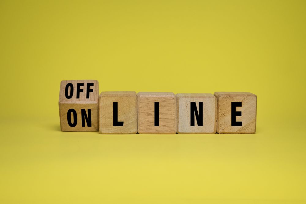 offline and online words on turn wooden blocks isolated on yellow background
