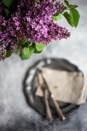 Spring table setting with lilacs above table
