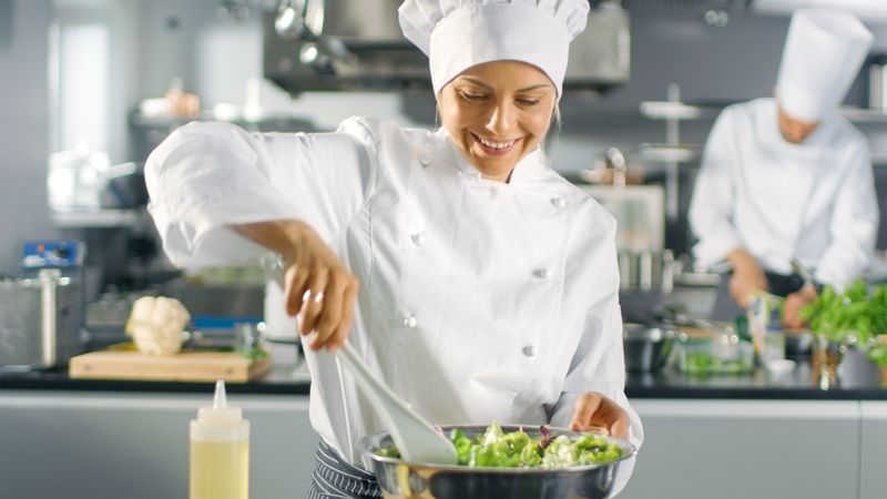 In a Famous Restaurant Female Cook Prepares Salad. She Works in a Big Modern Kitchen.