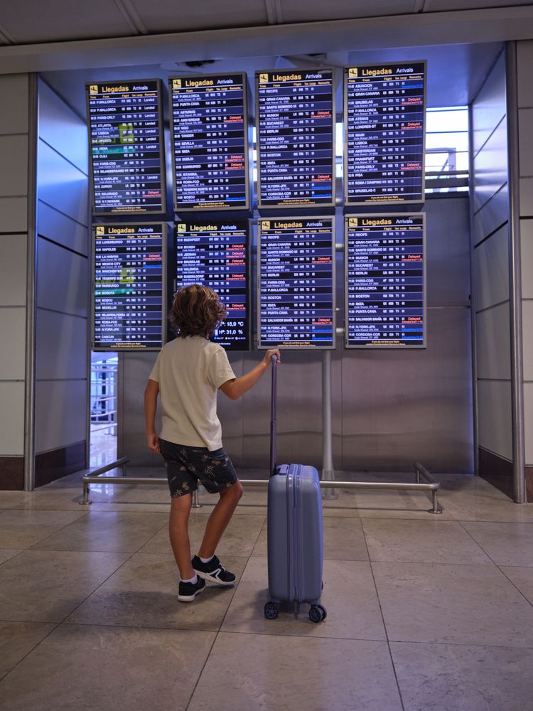 Unrecognizable boy in airport terminal