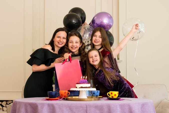 Family posing together during girl's birthday celebration