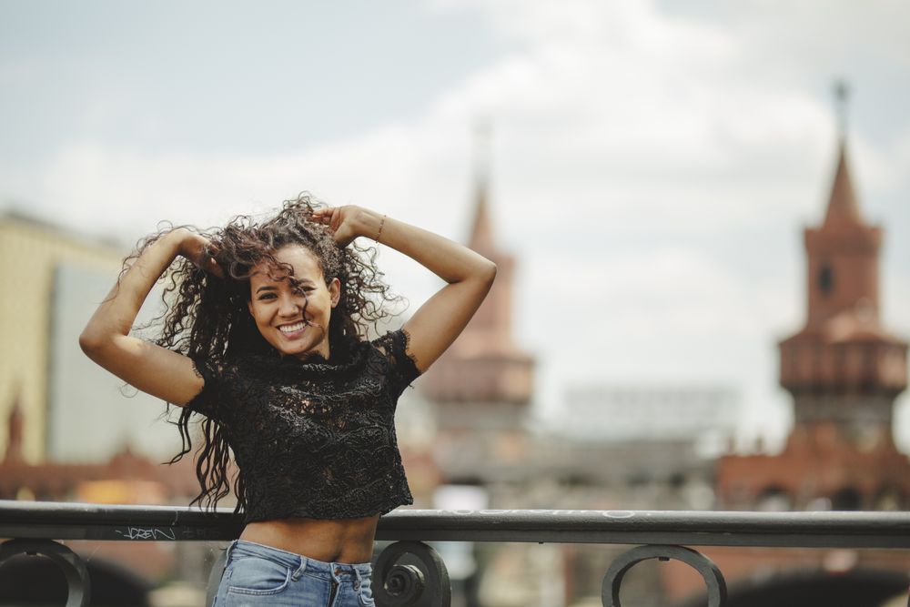 Hispanic woman leaning on railing