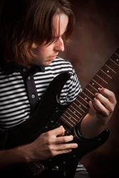 Young Musician Plays His Electric Guitar