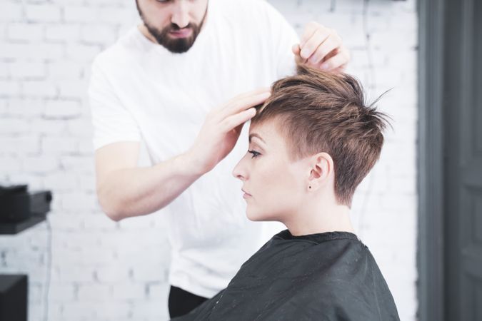 Hairdresser combing the woman's fingers