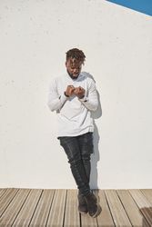 Stylish Black man looking at hands