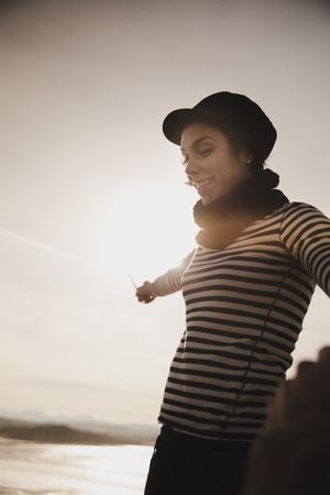 Woman in striped shirt at the coast