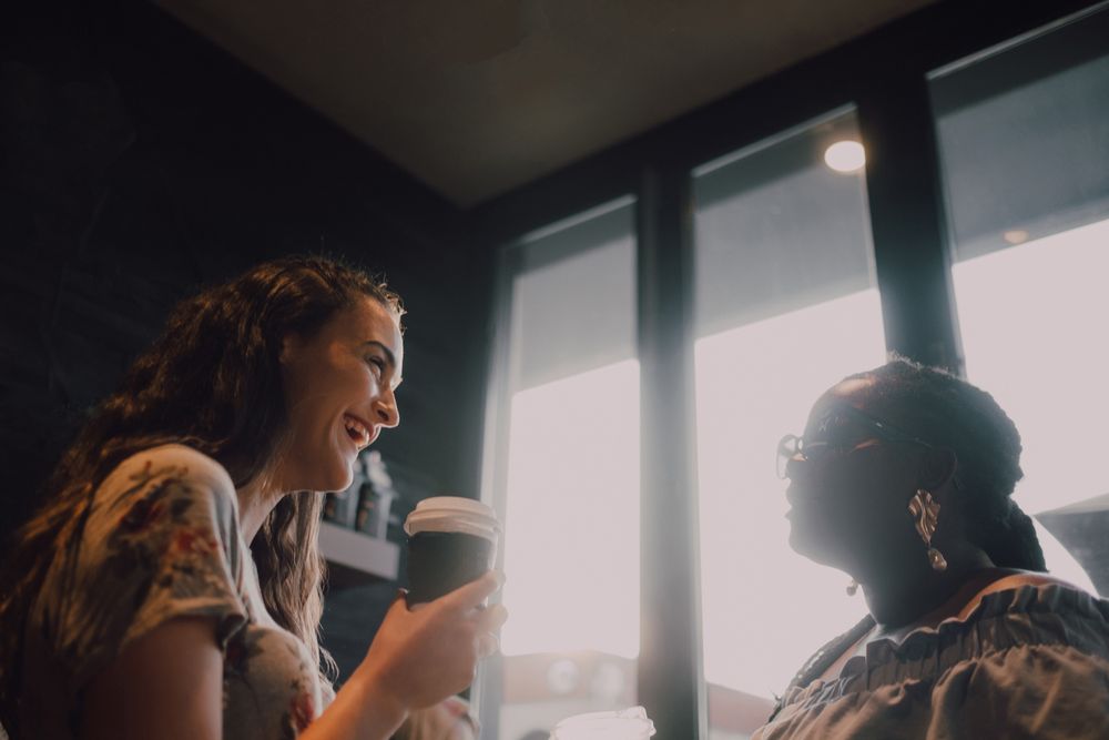 Multiethnic modern women relaxing at coffee shop