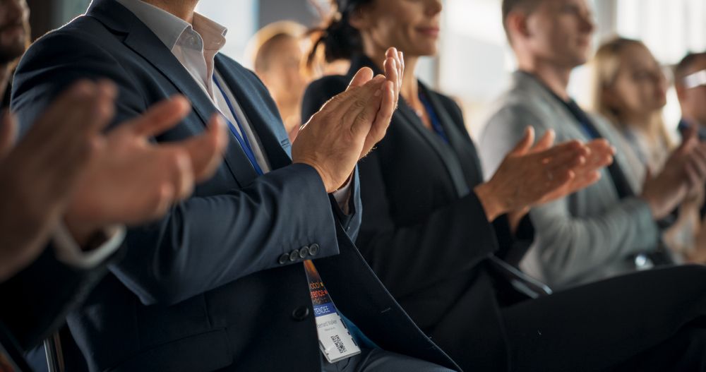 Close-Up on Hands of Audience Applauding in Concert Hall During Business Forum Presentation. Technology Summit Auditorium Room With Corporate Delegates. Excited Entrepreneurs Clapping.
