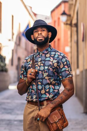 Stylish Black man walking on the city street