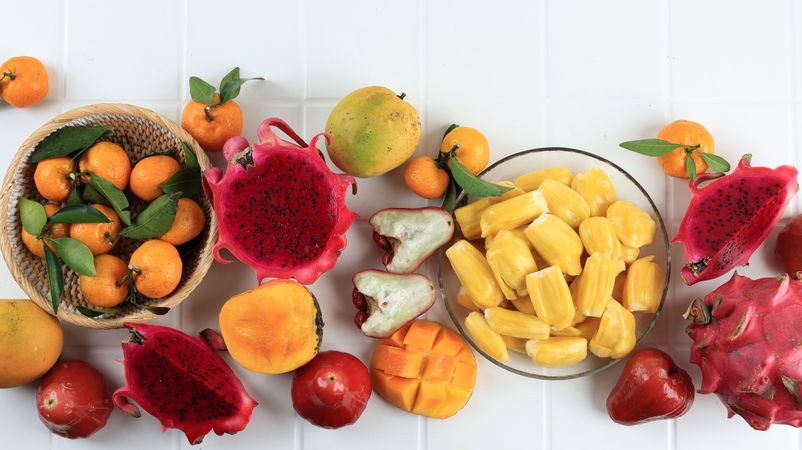 Top View Various Tropical Fruit, Mango, Dragon Fruit, Peelede jackfruit, Orange, and Water Guava
