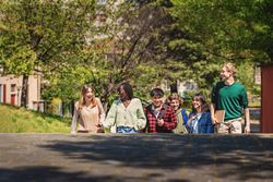 Multi-ethnic group of students walking up stairs on campus