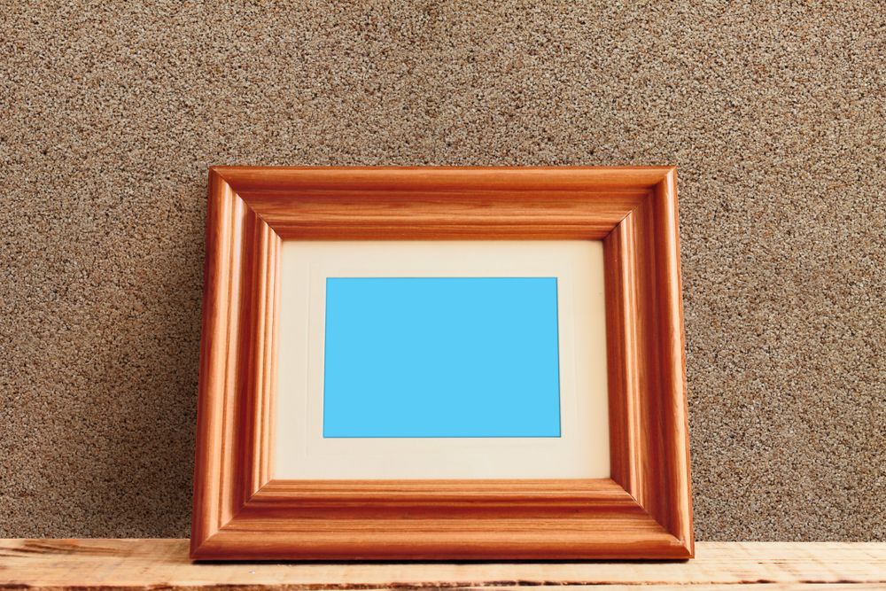 Rectangular wooden picture frame leaning against wall mockup
