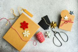 Christmas gifts being wrapped on table