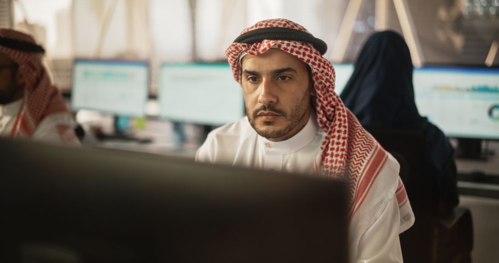 Arab Market Financial Analyst Working in a Research and Development Facility on a Desktop Computer.