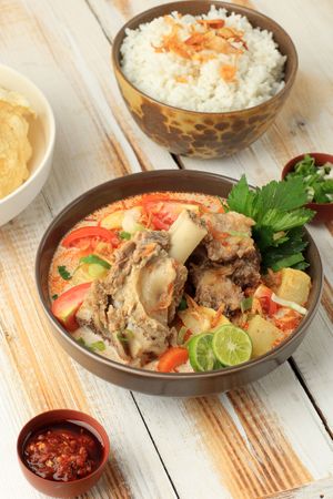 Bowl of Indonesian beef stew served on the bone with rice