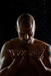 Bald man catching raindrops