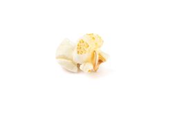 Piece of popcorn isolated on blank background, close up