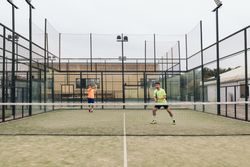 Two young man playing paddle tennis
