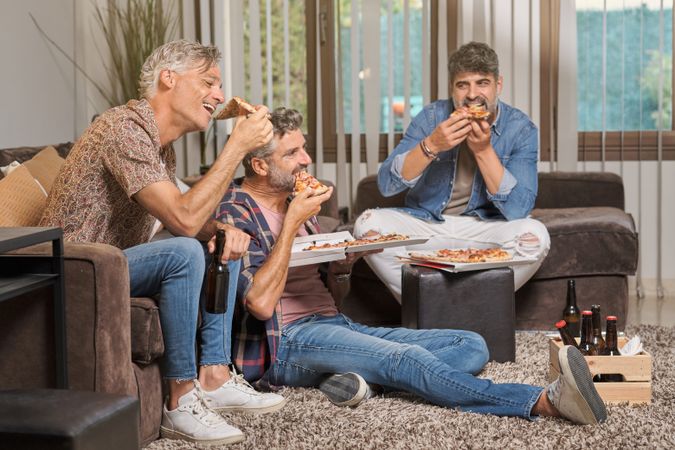 Cheerful group of friends eating pizza