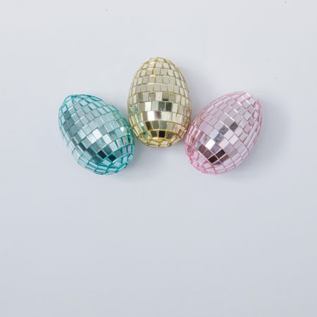 Disco ball Easter eggs in pink, blue and golden pastel colors