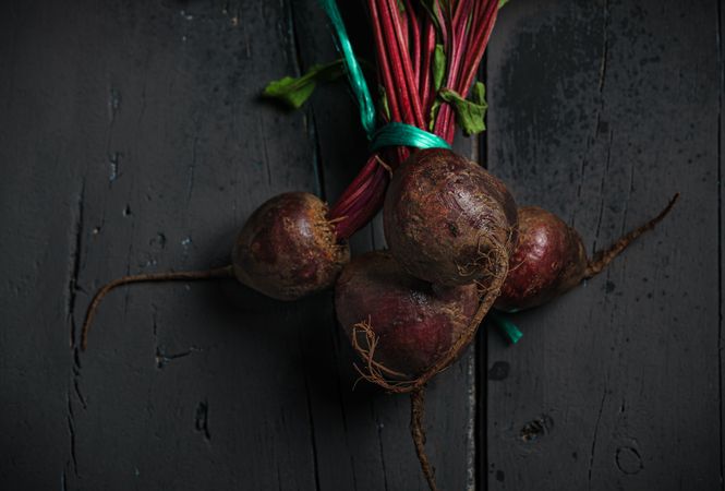 Bunch of raw beetroot with edible taproots and leaves