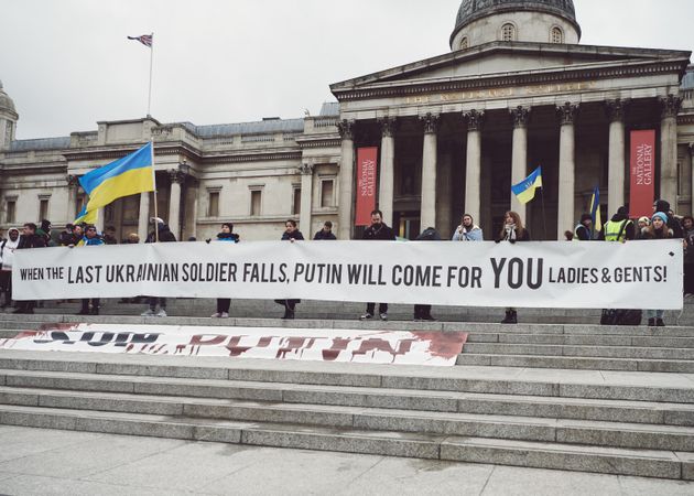 London, England, United Kingdom - March 5 2022: People with banner and Ukrainian flag