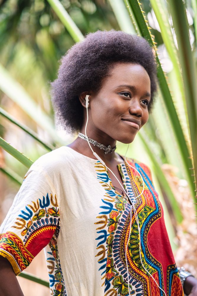 Smiling Black woman listening to music